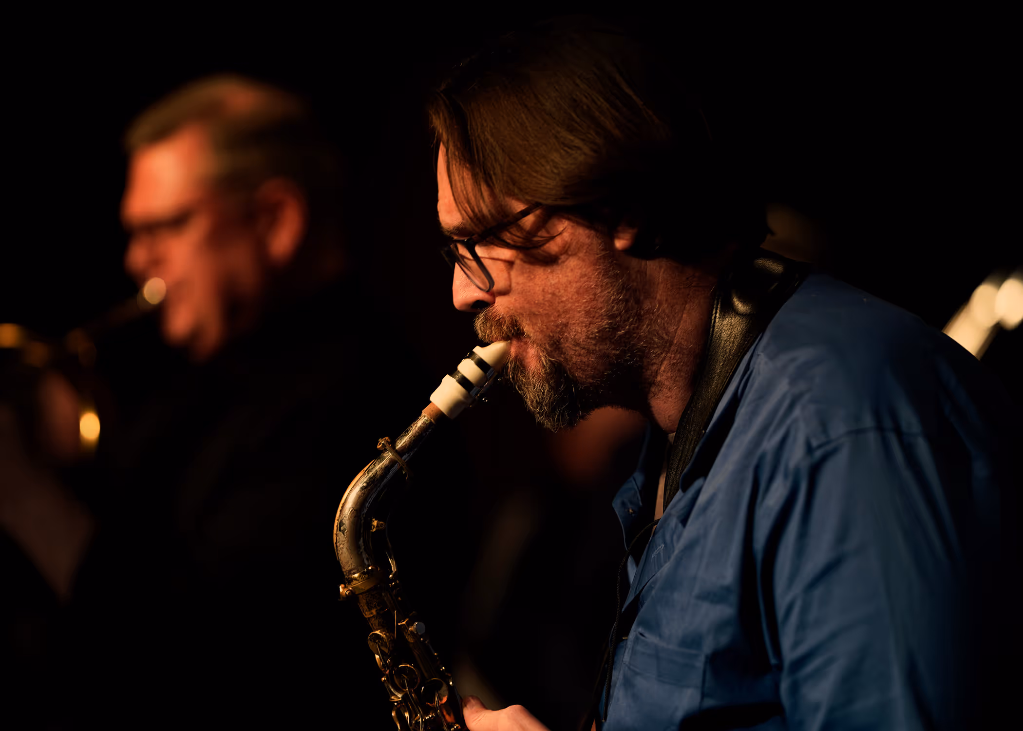 Simon Harding playing saxophone in profile